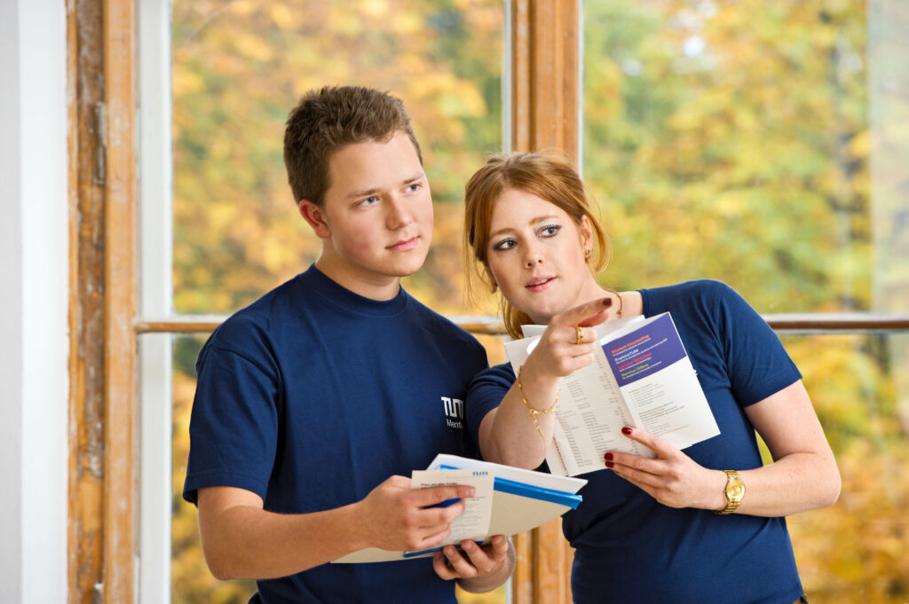 Two students at Technical University of Munich, the female student explaining EuroTech's education offers to the male student.
