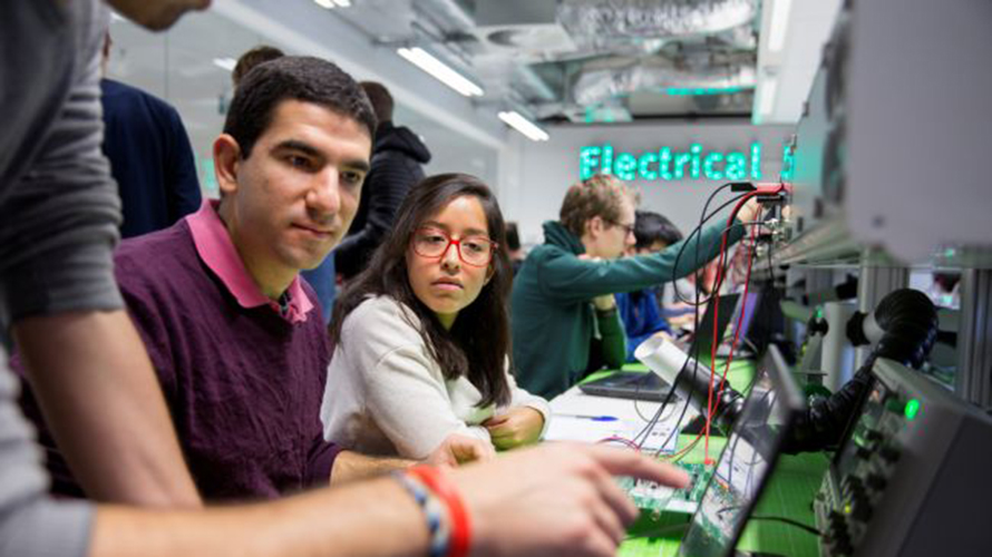 Students working at workplace in Flux building of departments of Applied Physics and Electrical Engineering at TU/e